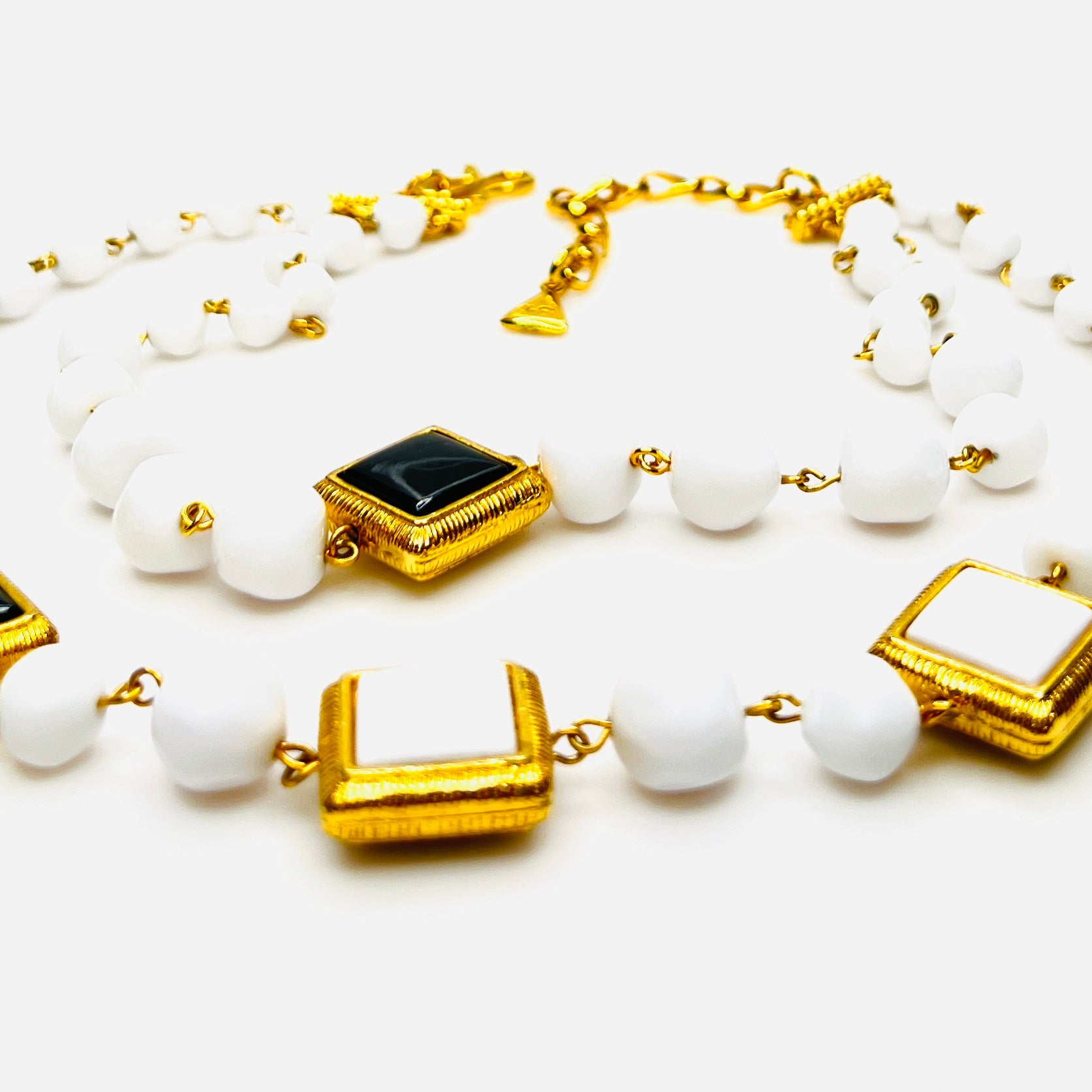 Close-up of Signed Liz Claiborne necklace and clip earring set with extender