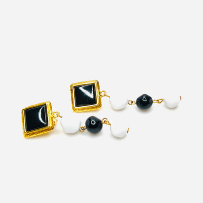 Side view of Vintage black white clip earrings with gold tone accents