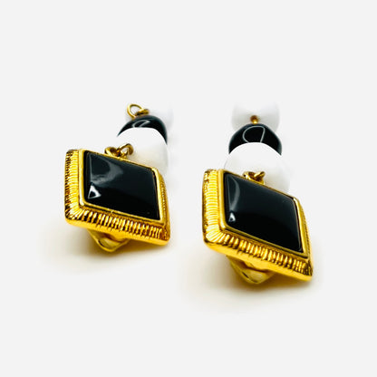 Side view of Vintage black white clip earrings with gold tone accents