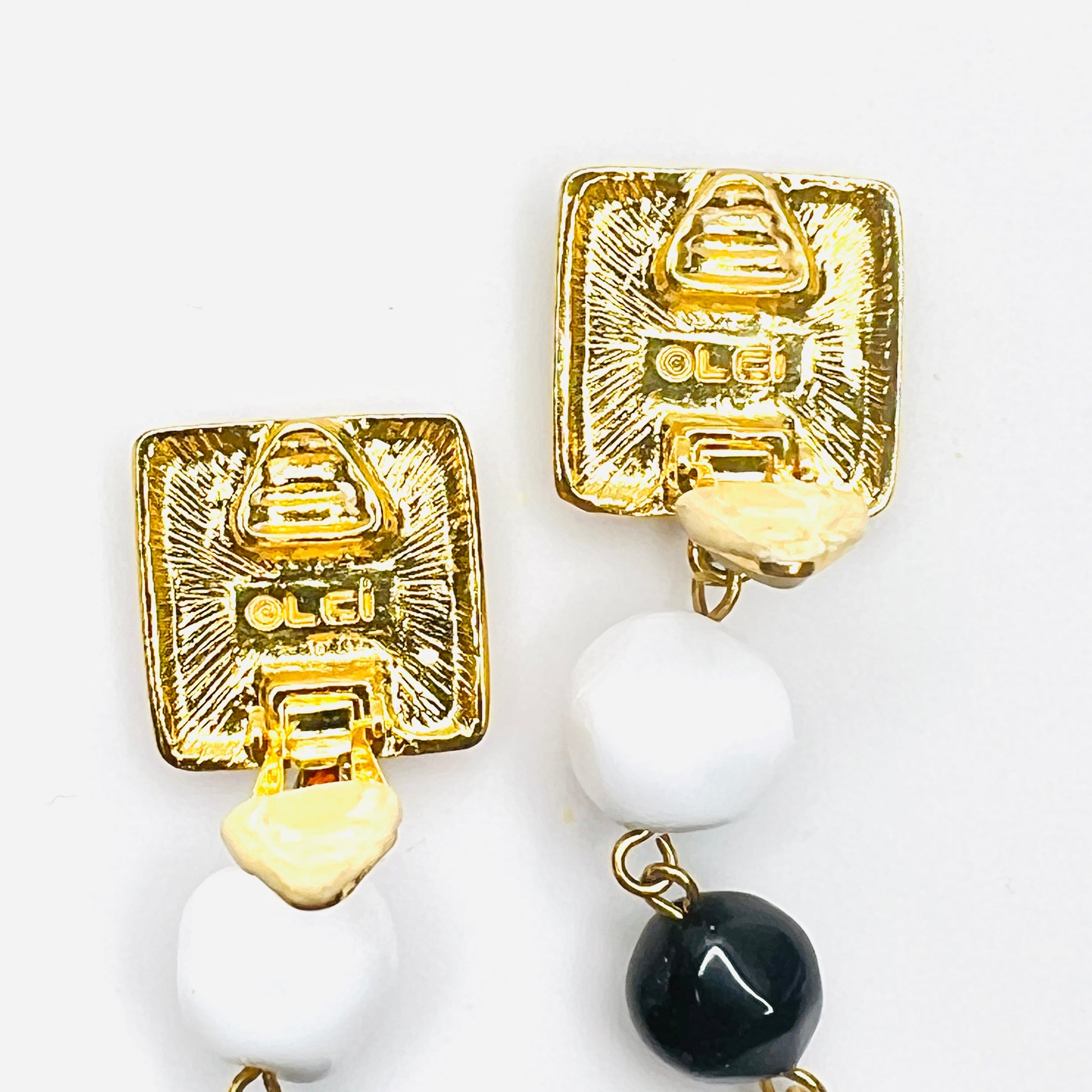 Close-up of Signed Liz Claiborne clip earring backs and bead drops