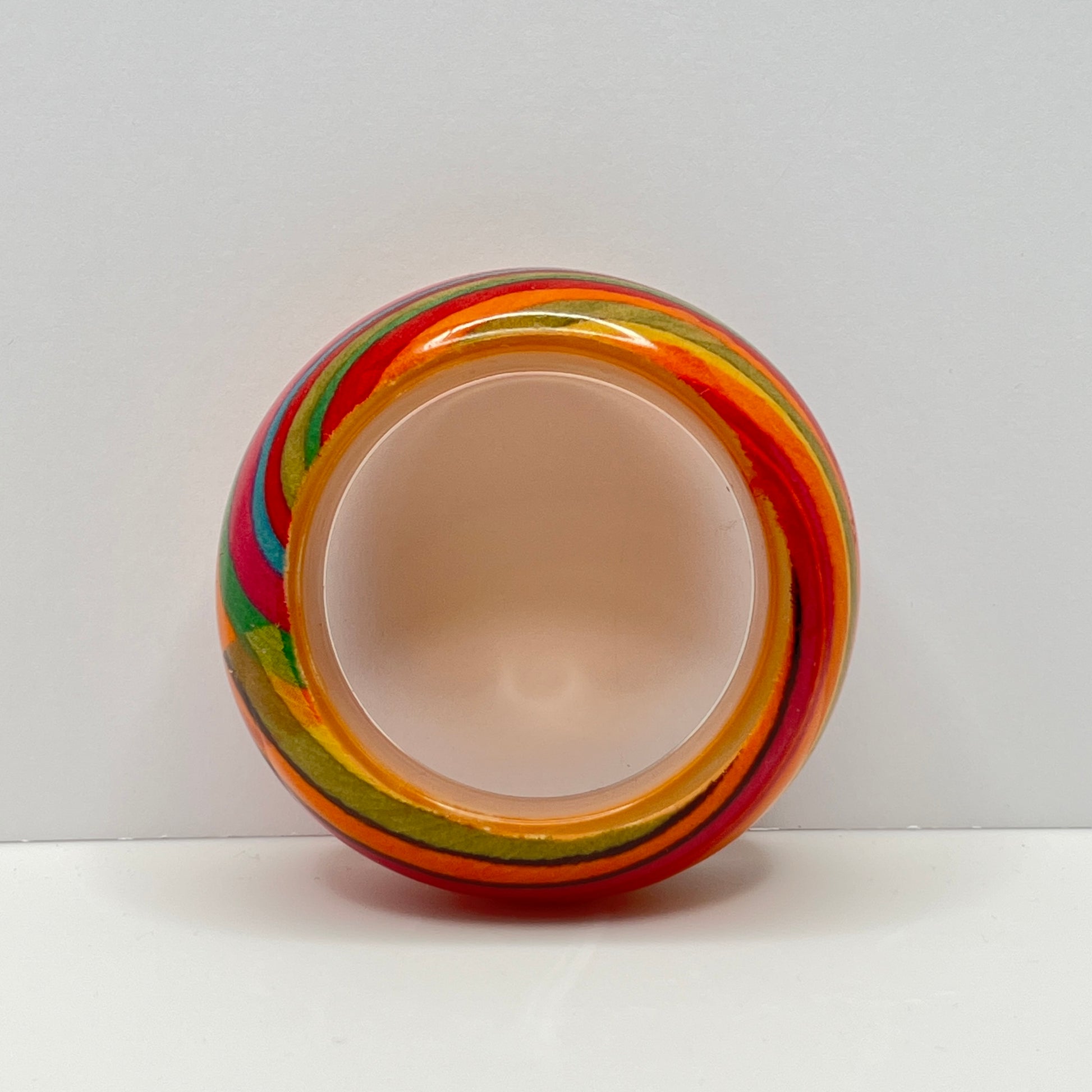 Wide retro lucite bangle bracelet with rainbow earth-tone stripes