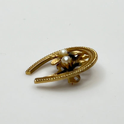 Vintage gold horseshoe brooch with flower and pearl detail