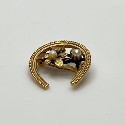 Vintage gold horseshoe brooch with flower and pearl detail