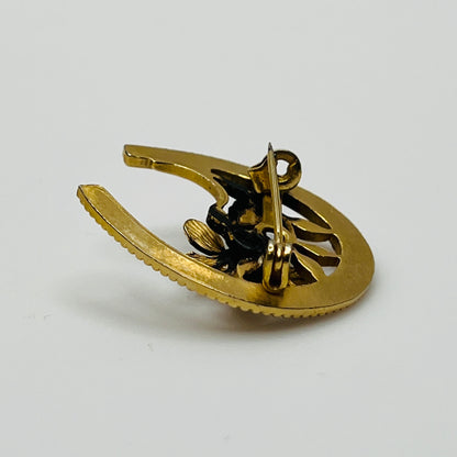 Back view of gold-tone horseshoe pin