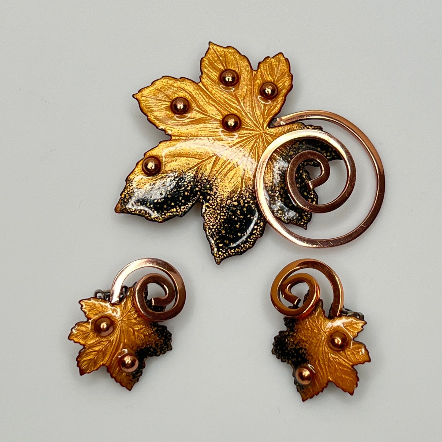 Matisse copper enamel maple leaf brooch and clip-on earring set in gold and black, signed mid-century vintage