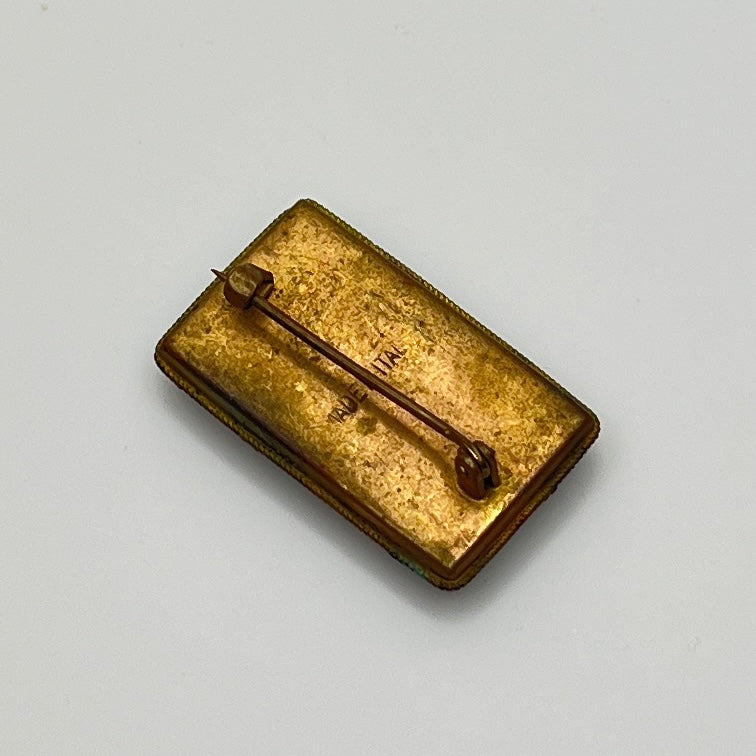 Back of micro mosaic brooch showing "Made in Italy" mark and C-clasp closure