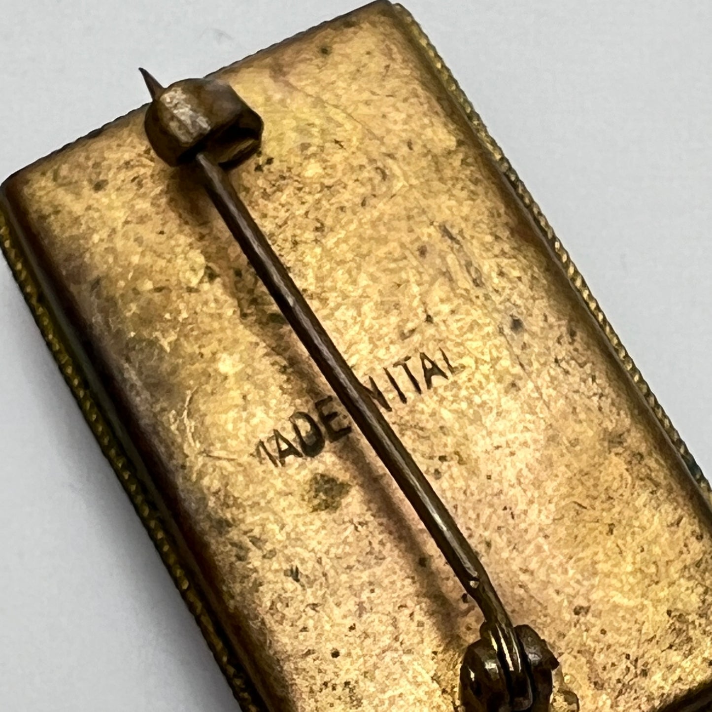 Back of micro mosaic brooch showing "Made in Italy" mark and C-clasp closure