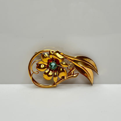 Vintage 12K gold-filled flower brooch with blue rhinestone center