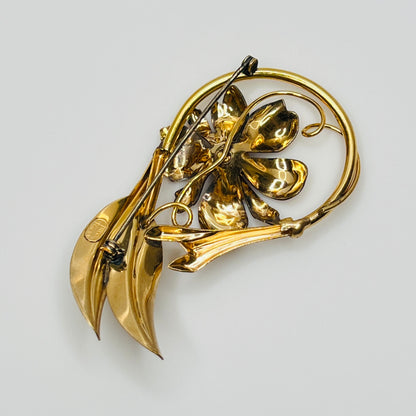 Signed A Regal floral brooch in gold-tone with crystal rhinestone