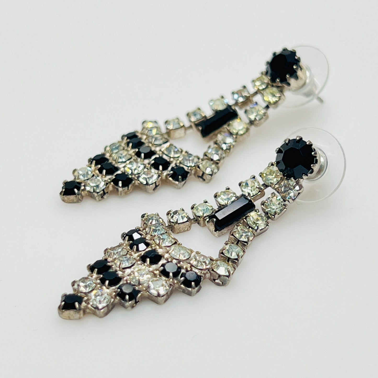 Art Deco-style earrings with black and clear rhinestones in a long silver-tone design