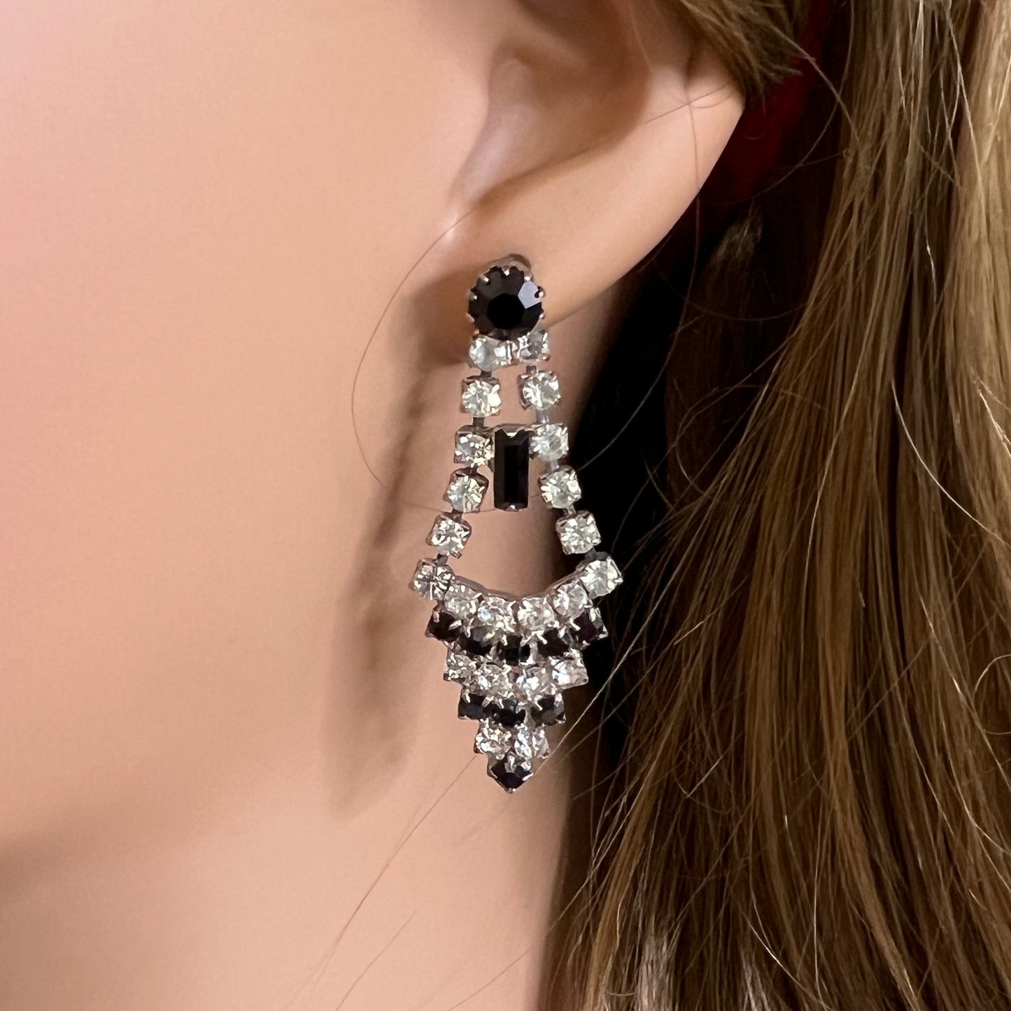 Art Deco-style earrings with black and clear rhinestones in a long silver-tone design