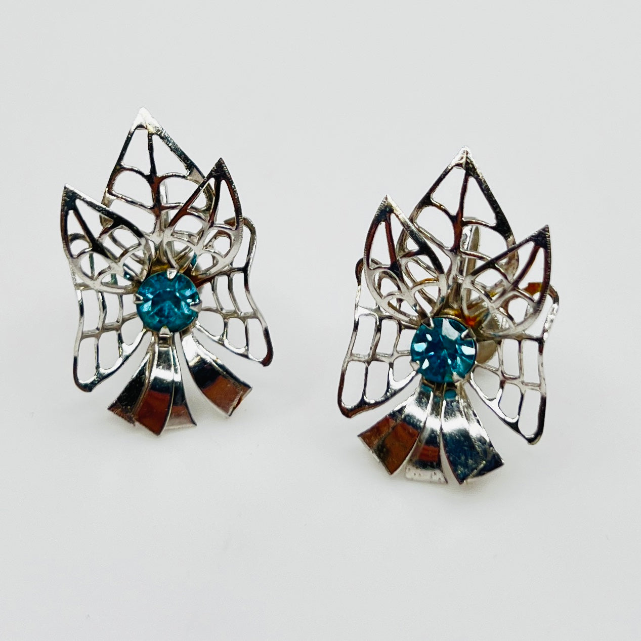 Silver-tone earrings with blue rhinestones in Mid-Century starburst design