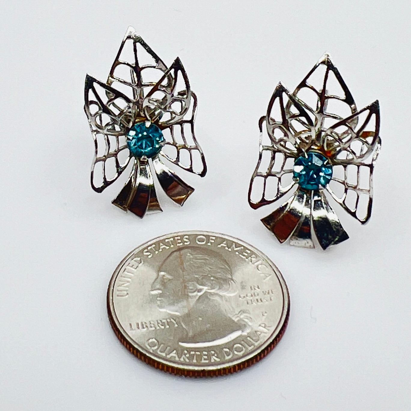 Silver-tone earrings with blue rhinestones in Mid-Century starburst design