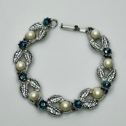 Close-up of vintage silver bracelet with aurora borealis stones and pearl details