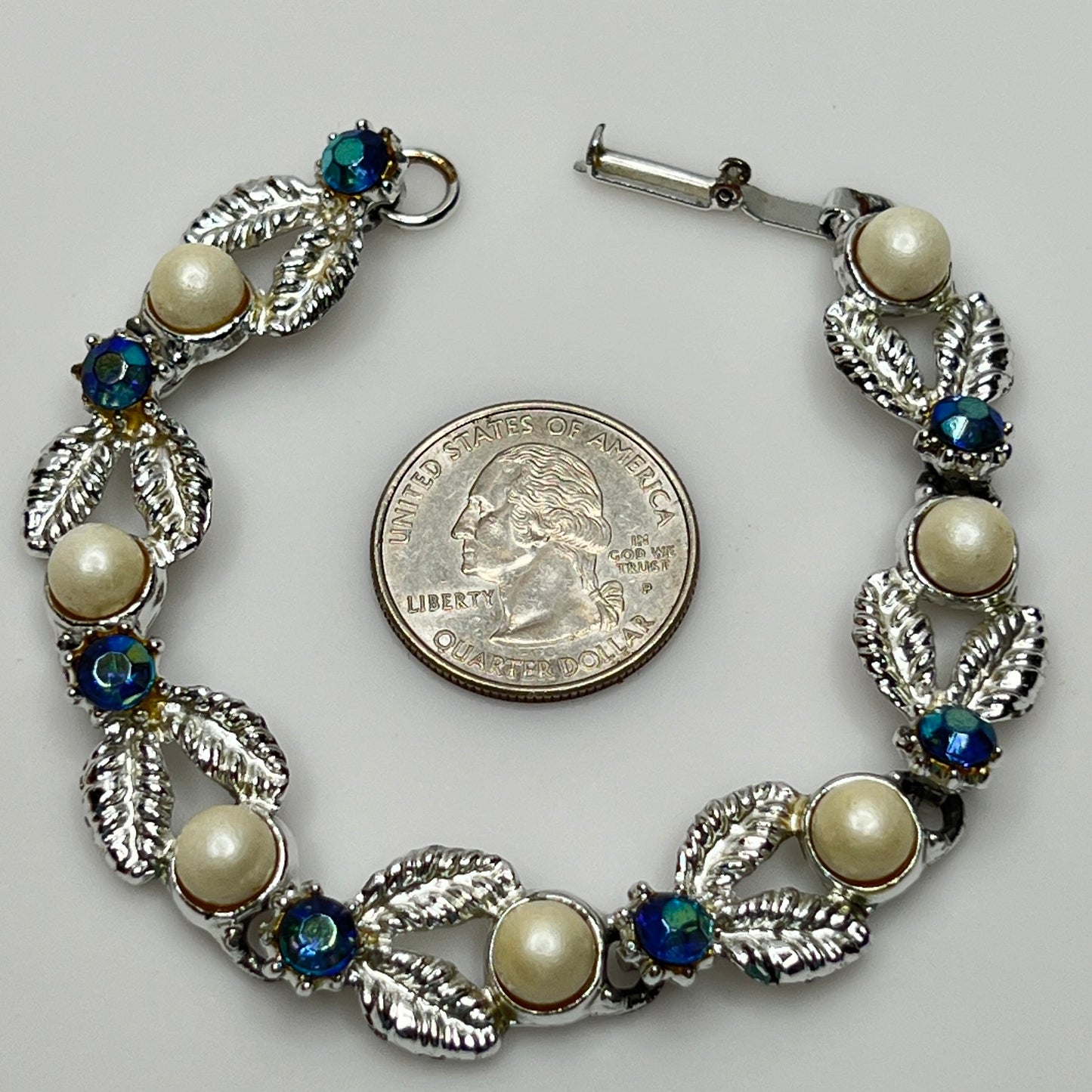Close-up of vintage silver bracelet with aurora borealis stones and pearl details
