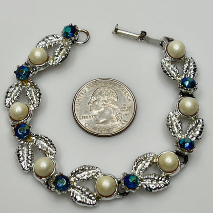 Close-up of vintage silver bracelet with aurora borealis stones and pearl details