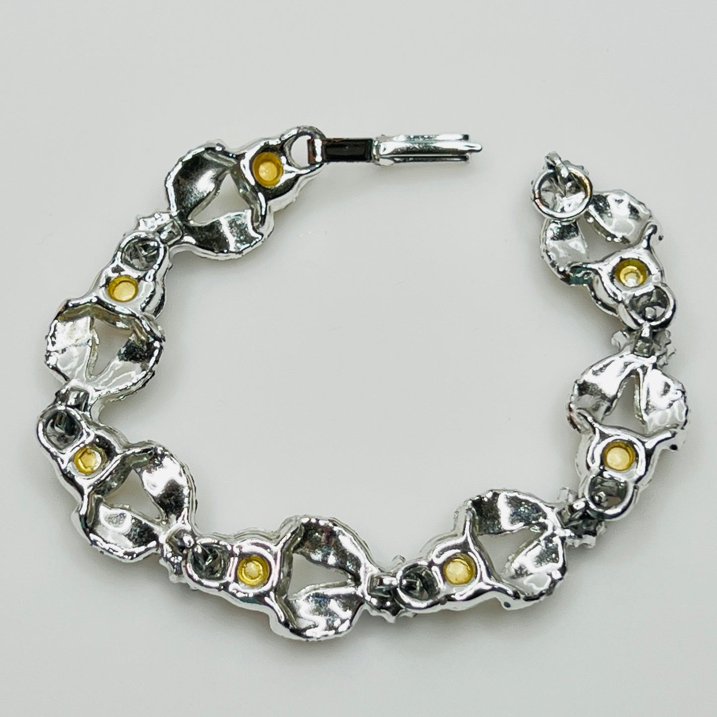 Close-up of vintage silver bracelet with aurora borealis stones and pearl details