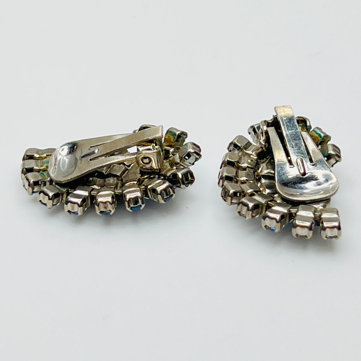 Close-up of teardrop and round rhinestones in silver-tone setting