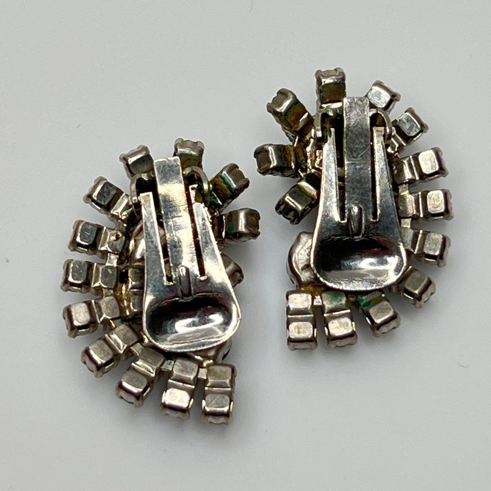 Close-up of teardrop and round rhinestones in silver-tone setting