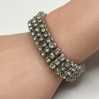 Close-up of vintage silver-tone accordion rhinestone bracelet on wrist