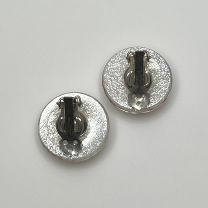 Mid-century plastic earrings with suspended confetti sparkle