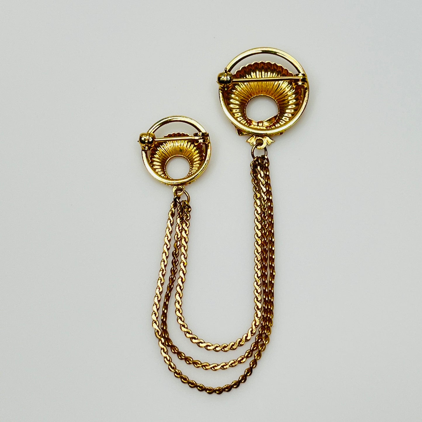 Mid-century gold chatelaine brooch with double wreaths, bow detail, and triple chain drape