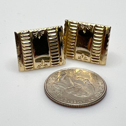 Close-up of 1930s gold cufflinks next to U.S. quarter for scale