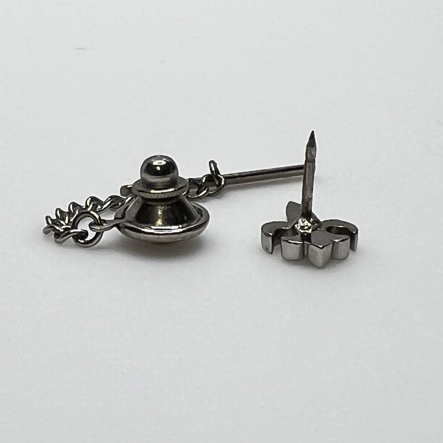Vintage silver fleur-de-lis tie tack with chain and clutch backing.
