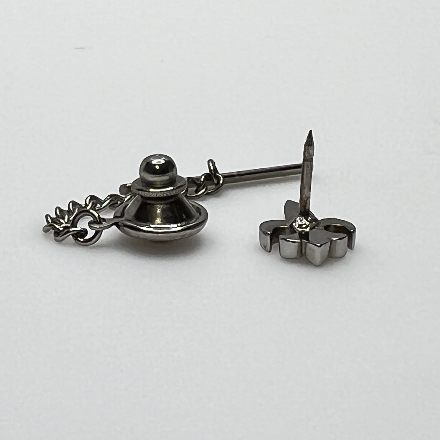 Vintage silver fleur-de-lis tie tack with chain and clutch backing.