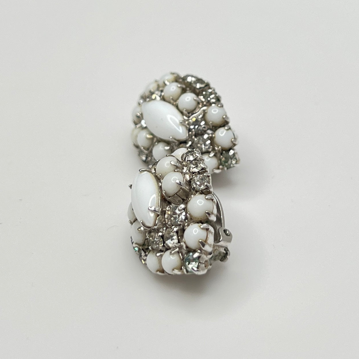 Mid-century milk glass and rhinestone clip-on earrings in marquise shape