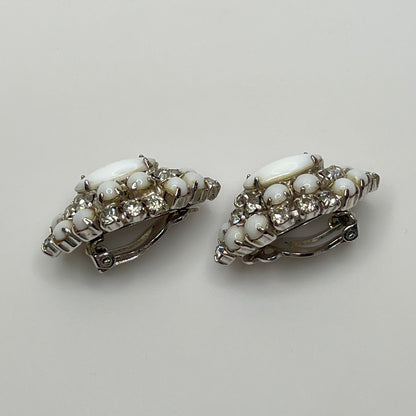 White vintage clip earrings with clear rhinestones and oval centers