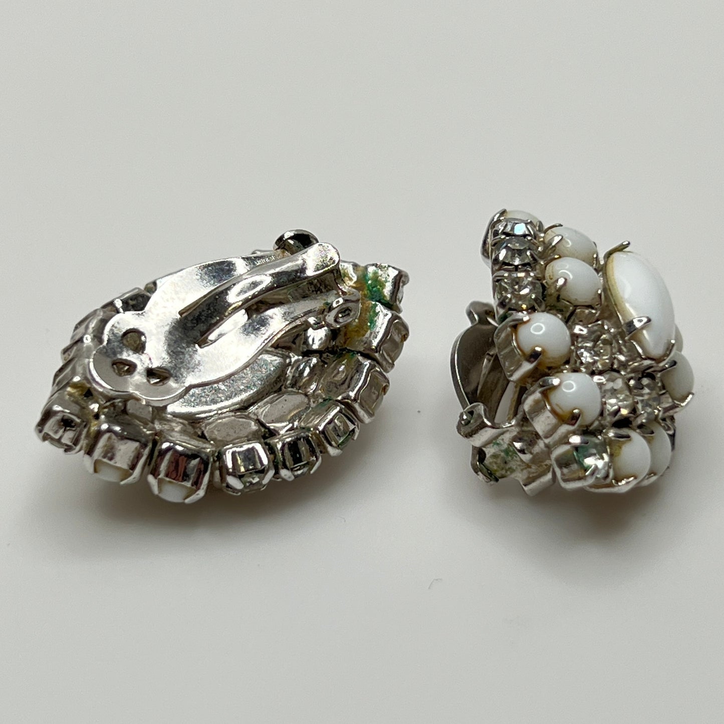 White vintage clip earrings with clear rhinestones and oval centers