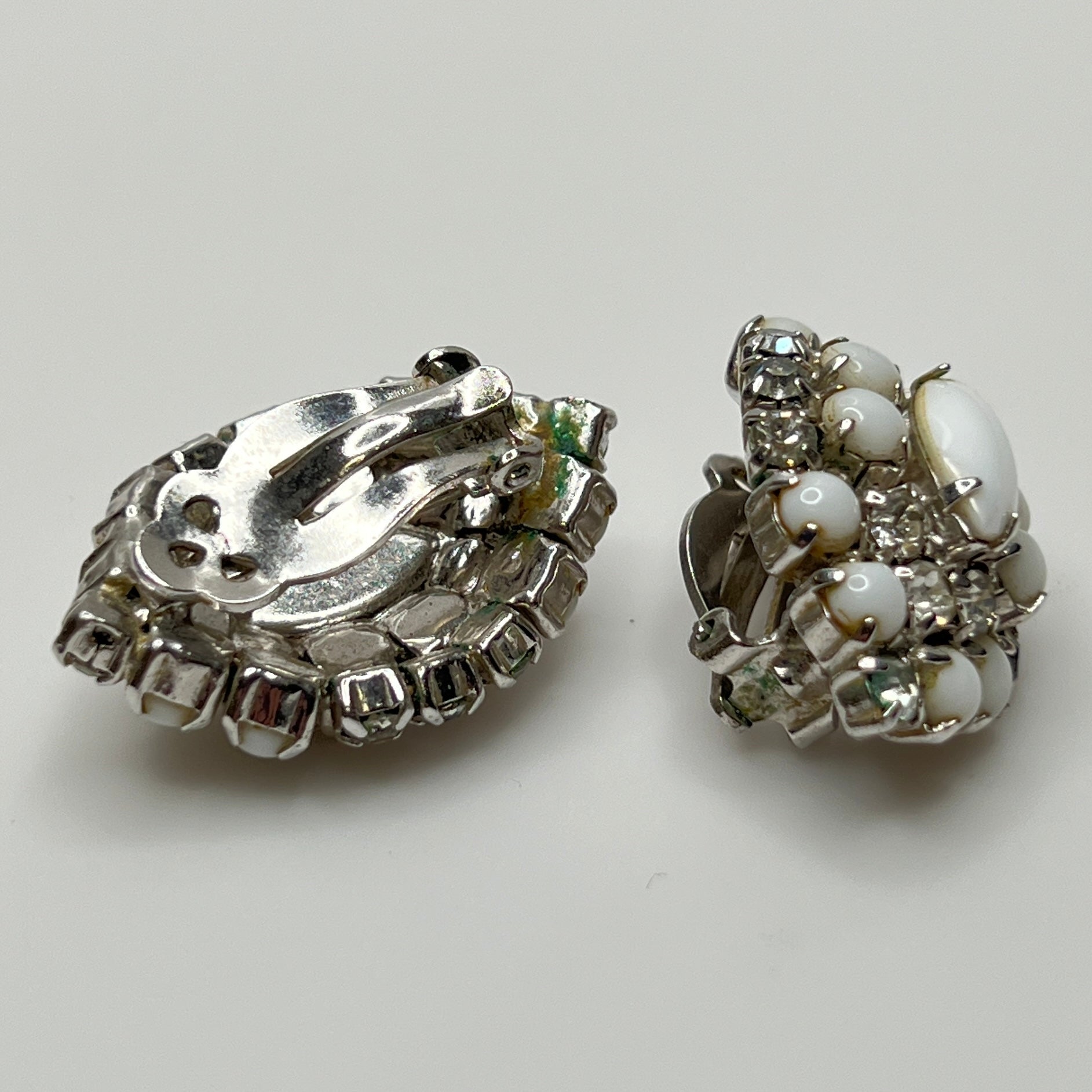 White vintage clip earrings with clear rhinestones and oval centers