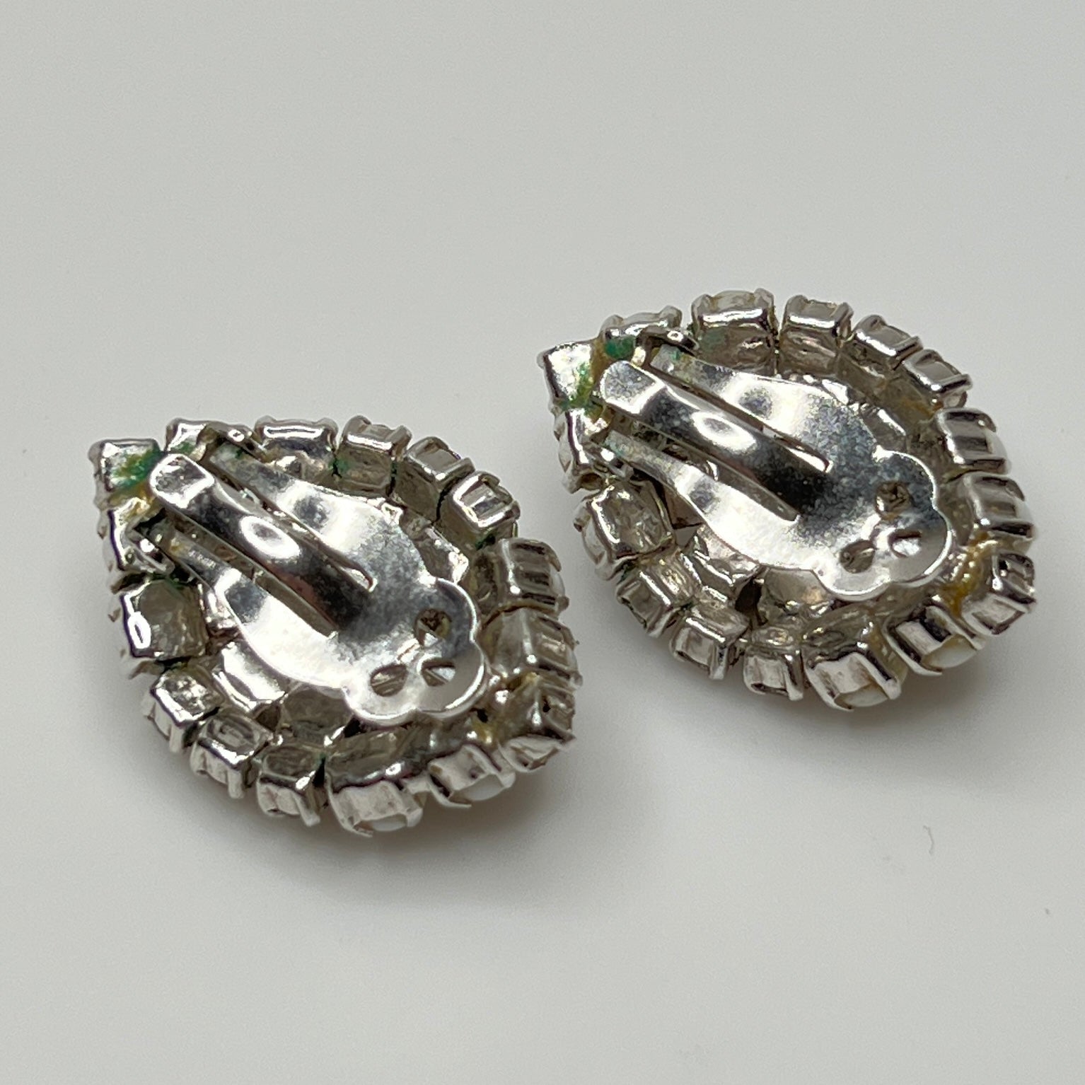1950s milk glass rhinestone earrings with sculptural silver-tone setting