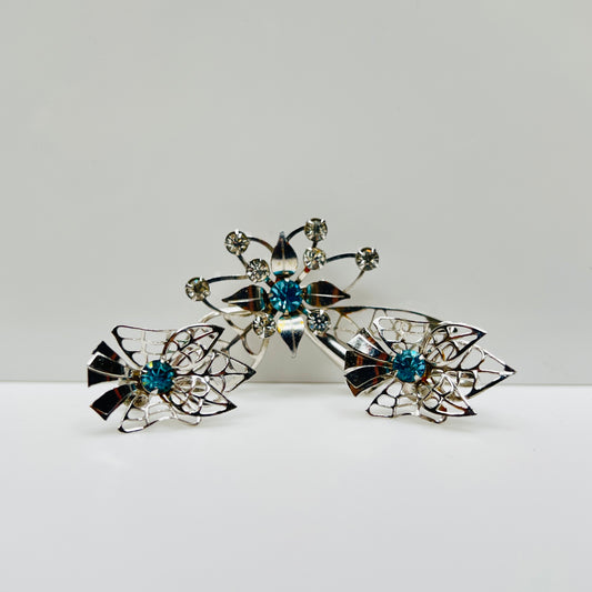 Silver-tone brooch and earrings set with blue rhinestones in Mid-Century starburst design