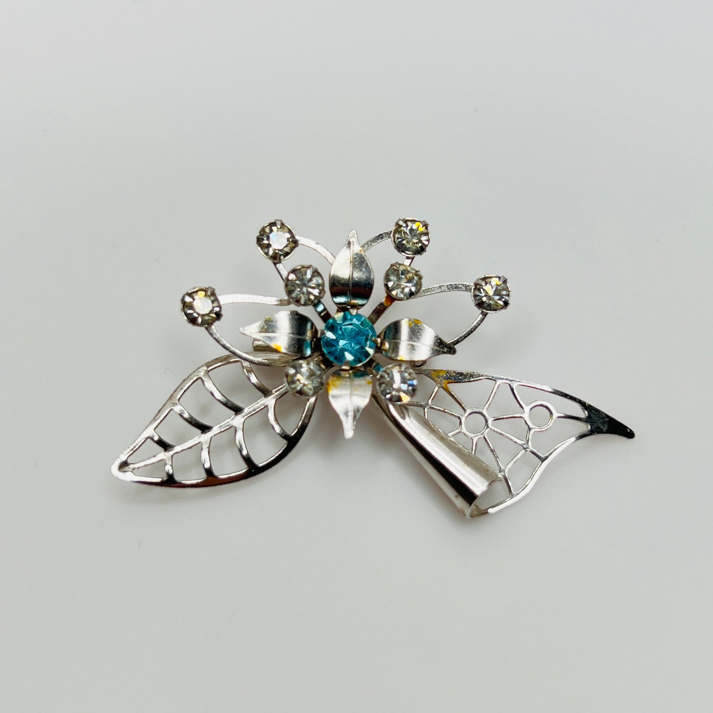 Close-up of brooch with prong-set rhinestones