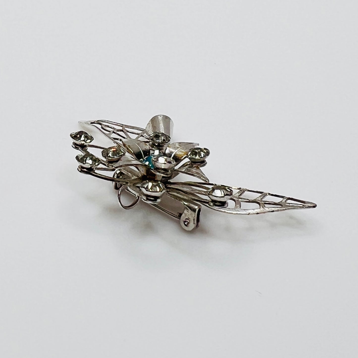 Close-up of brooch with prong-set rhinestones