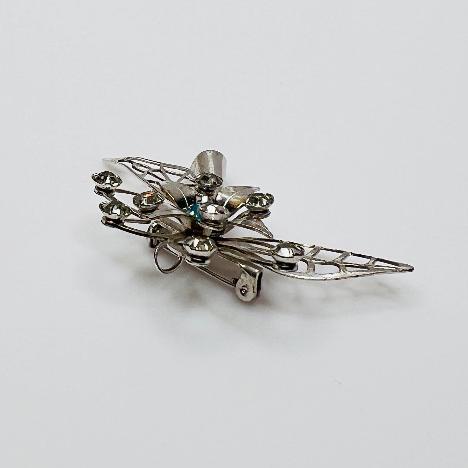 Close-up of brooch with prong-set rhinestones