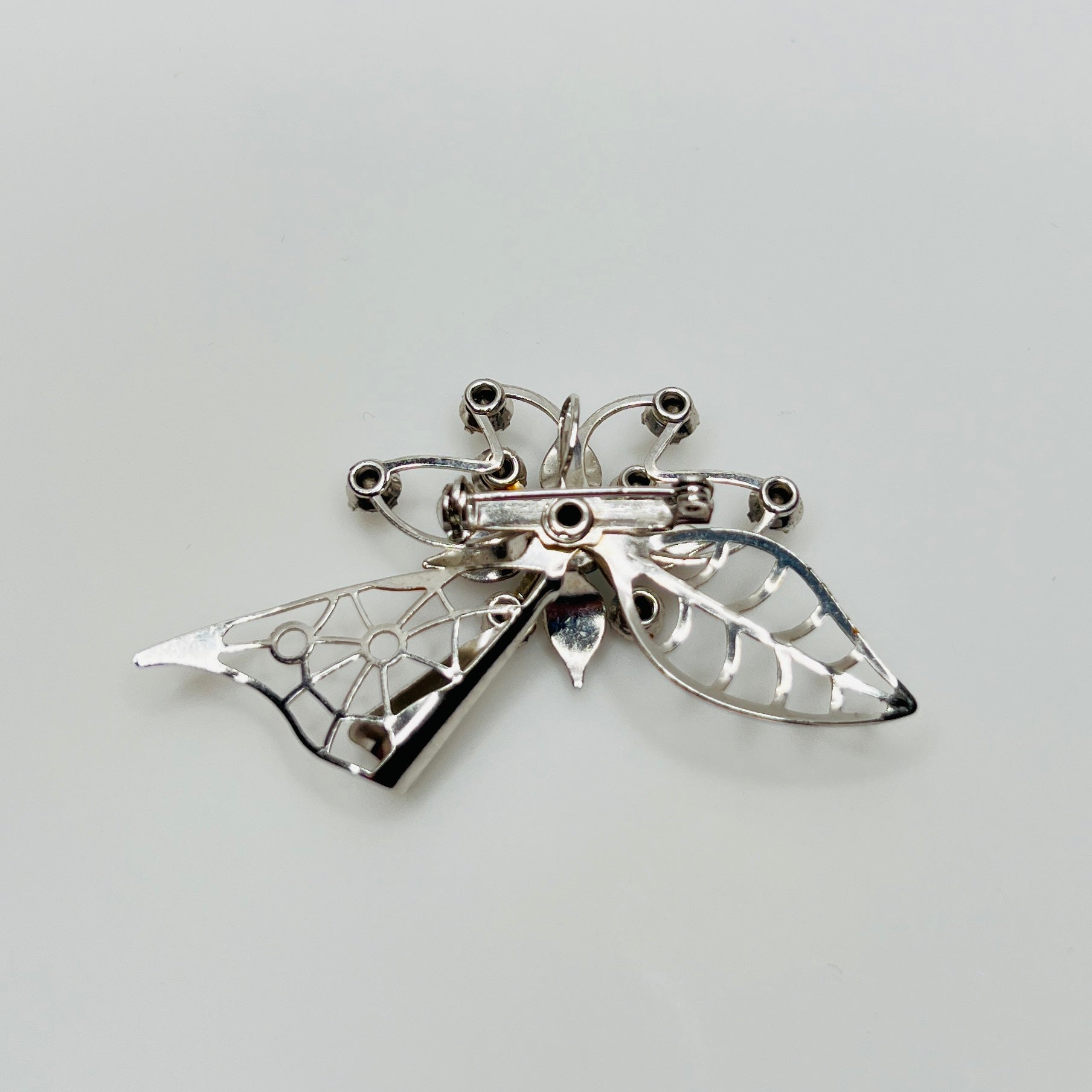 Close-up of brooch with prong-set rhinestones