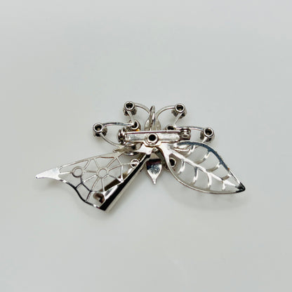Close-up of brooch with prong-set rhinestones