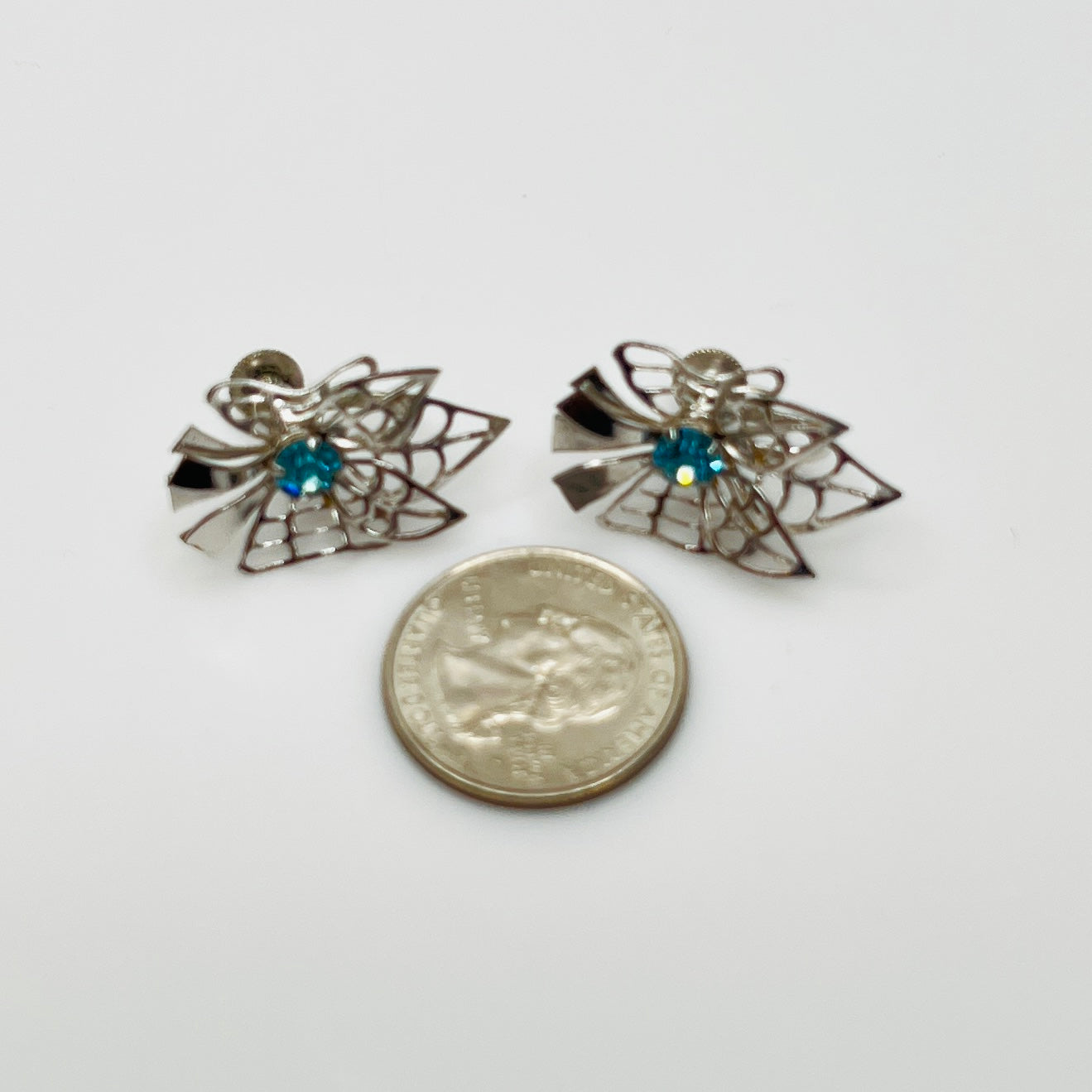 Close-up of filigree earrings with prong-set rhinestones