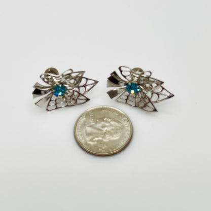 Close-up of filigree earrings with prong-set rhinestones