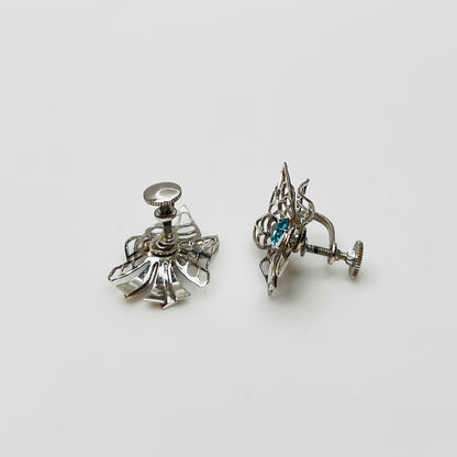 Close-up of filigree earrings with prong-set rhinestones