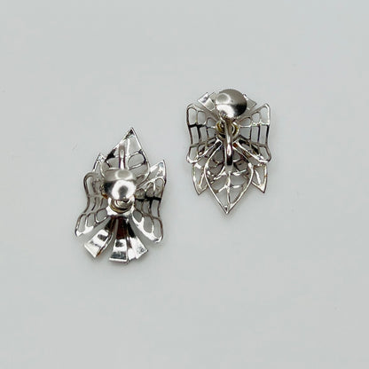 Close-up of filigree earrings with prong-set rhinestones