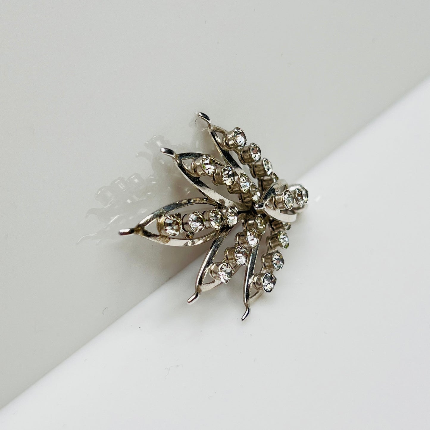Silver-tone rhinestone leaf brooch with openwork design