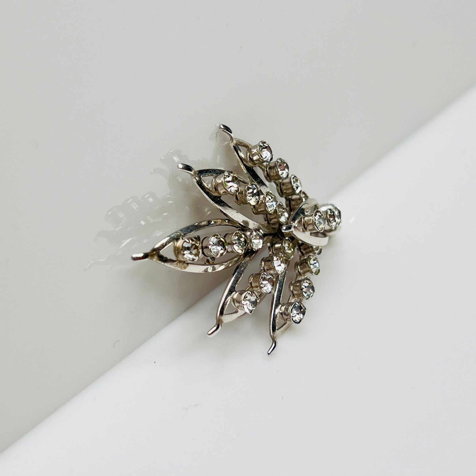 Silver-tone rhinestone leaf brooch with openwork design