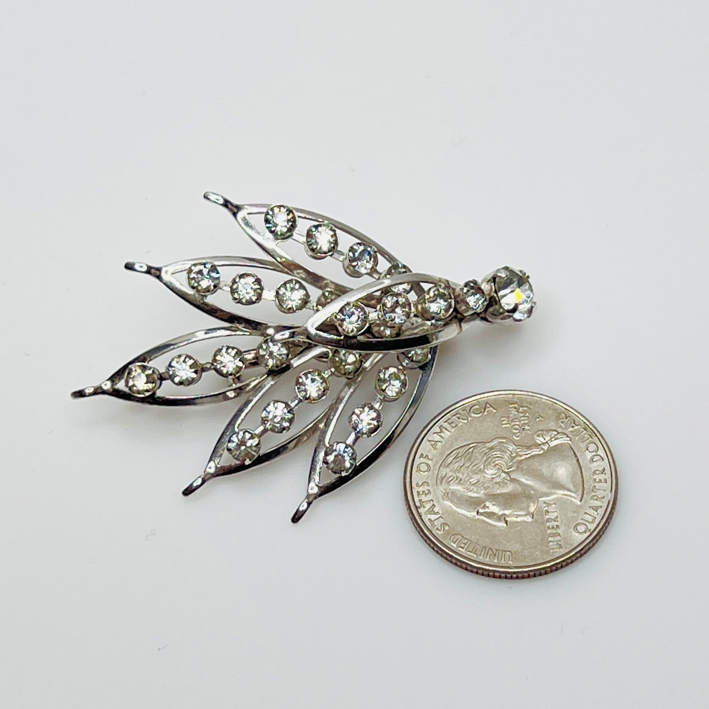 Close-up of vintage rhinestone brooch with prong-set stones