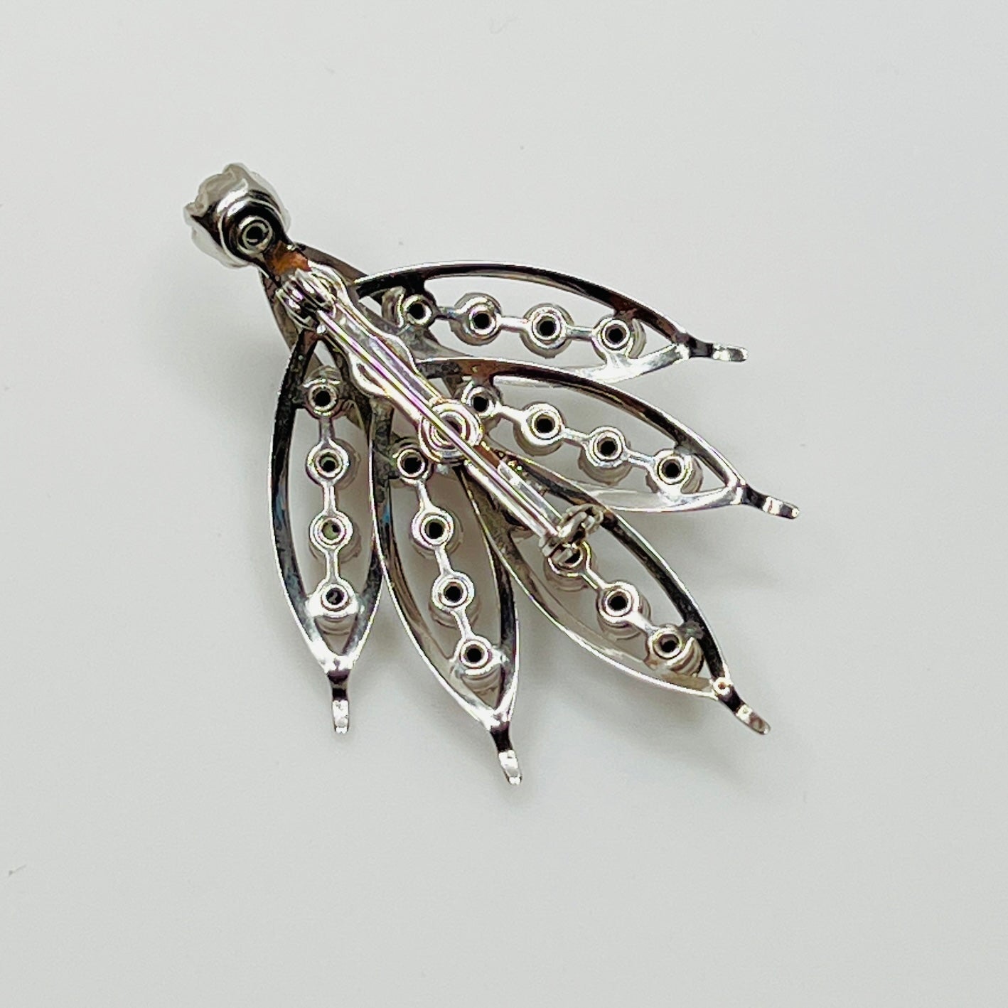 Close-up of vintage rhinestone brooch with prong-set stones