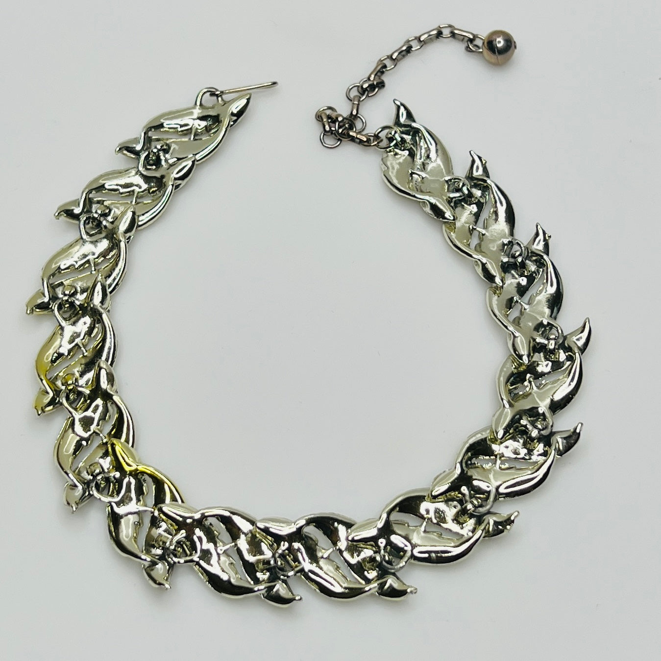 Mid-century silver-tone choker necklace with sculpted leaf links and hook extender clasp.