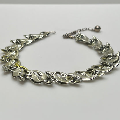 Mid-century silver-tone choker necklace with sculpted leaf links and hook extender clasp.